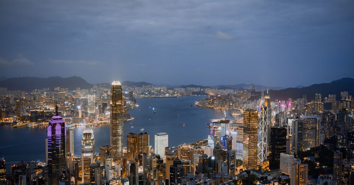 A breathtaking view of Hong Kong's illuminated skyline and harbor at night.